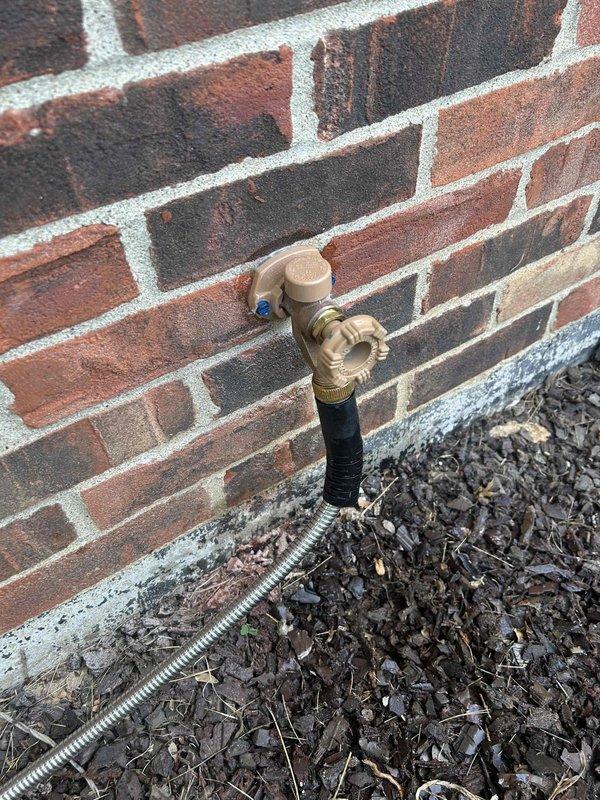 Responded to urgent water leak call where remediation company was actively on site removing drywall due to water intrusion. Upon inspection, identified the exterior hose bibb as the source of the leak. The brass hose bib mounted on the brick exterior wall showed signs of failure at the connection point. Replaced the defective hose bibb with new frost-proof unit, ensuring proper seal and secure mounting to prevent future leaks. Tested the new installation under full water pressure to verify no leaks were present. Coordinated with remediation crew to confirm leak source was successfully eliminated, allowing them to proceed with drywall restoration work.