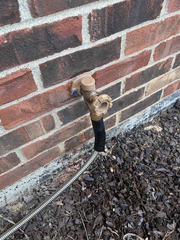 Responded to urgent water leak call where remediation company was actively on site removing drywall due to water intrusion. Upon inspection, identified the exterior hose bibb as the source of the leak. The brass hose bib mounted on the brick exterior wall showed signs of failure at the connection point. Replaced the defective hose bibb with new frost-proof unit, ensuring proper seal and secure mounting to prevent future leaks. Tested the new installation under full water pressure to verify no leaks were present. Coordinated with remediation crew to confirm leak source was successfully eliminated, allowing them to proceed with drywall restoration work.