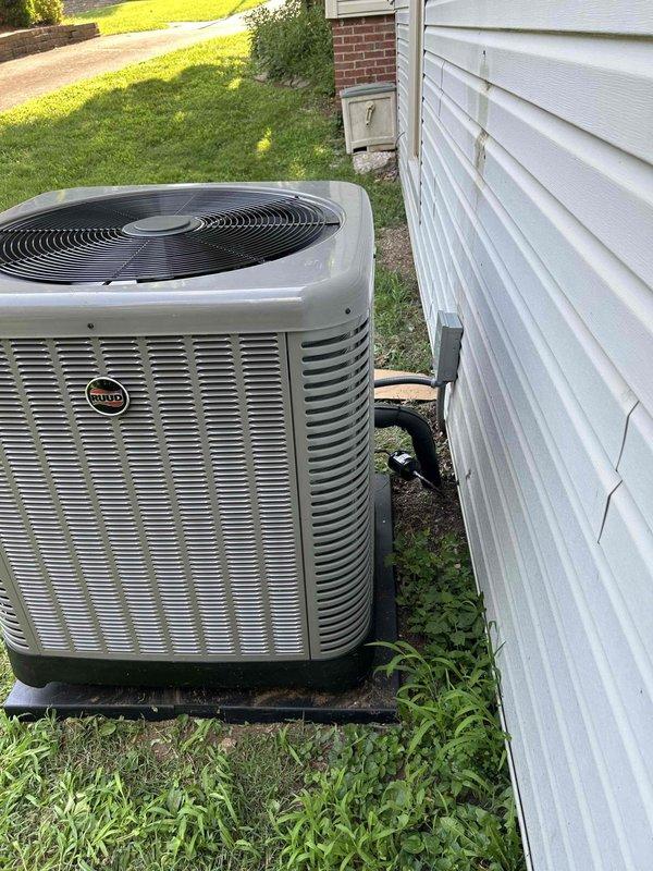 Completed full residential heat pump system installation featuring a Ruud 14.3 SEER2 two-stage 3.5 ton heat pump (model RP14AY42AJ2NA) with matching air handler (RH2TY4821STANNA) and auxiliary heat kit (JRXBH-1724A15J-B). Removed and disposed of existing HVAC equipment, then installed new outdoor heat pump unit on composite pad with snow legs for elevated clearance. Installed electrical disconnect box, whip kit, and ran refrigerant lines with proper insulation and inline filter. Mounted indoor air handler with transition to existing ductwork, integrated auxiliary electric heat kit, and installed overflow drain pan with water sensor, trap, and SS2 coil drain safety sensor for flood protection. Added standard-sized filter rack and programmed new digital thermostat for two-stage operation. Secured all applicable permits, verified code compliance, tested system operation across both heating and cooling stages, and confirmed proper refrigerant charge and airflow. System operational and cust