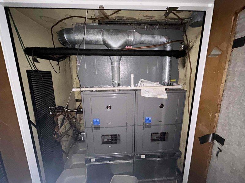 Responded to no cooling complaint on commercial HVAC system with dual electric furnace units located in 3rd floor mechanical closet. Performed diagnostic inspection of 10-year-old equipment, documented existing conditions including ductwork configuration, electrical connections, and unit accessibility. Photographed installation layout showing both furnace cabinets, horizontal supply ductwork, and control interfaces for service records and further evaluation of cooling system malfunction.