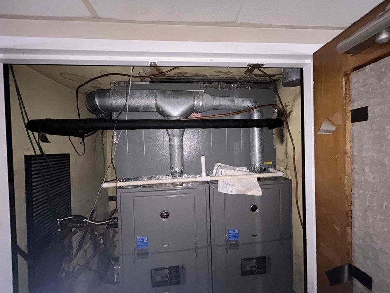 Responded to no cooling complaint on commercial HVAC system with dual electric furnace units located in 3rd floor mechanical closet. Performed diagnostic inspection of 10-year-old equipment, documented existing conditions including ductwork configuration, electrical connections, and unit accessibility. Photographed installation layout showing both furnace cabinets, horizontal supply ductwork, and control interfaces for service records and further evaluation of cooling system malfunction.