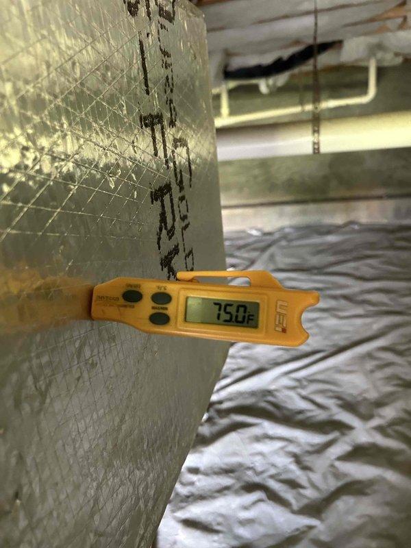 Responded to no cooling complaint on system less than 10 years old. Upon arrival, performed diagnostic assessment of HVAC system including temperature measurements at supply registers and ductwork in crawl space area, which indicated 75°F reading. Inspected and removed heavily soiled air filter showing significant dust and debris accumulation, which was restricting airflow and contributing to reduced system performance. Documented system conditions through photography for service records. Advised on proper filter maintenance schedule to prevent future airflow restrictions and maintain optimal system efficiency.