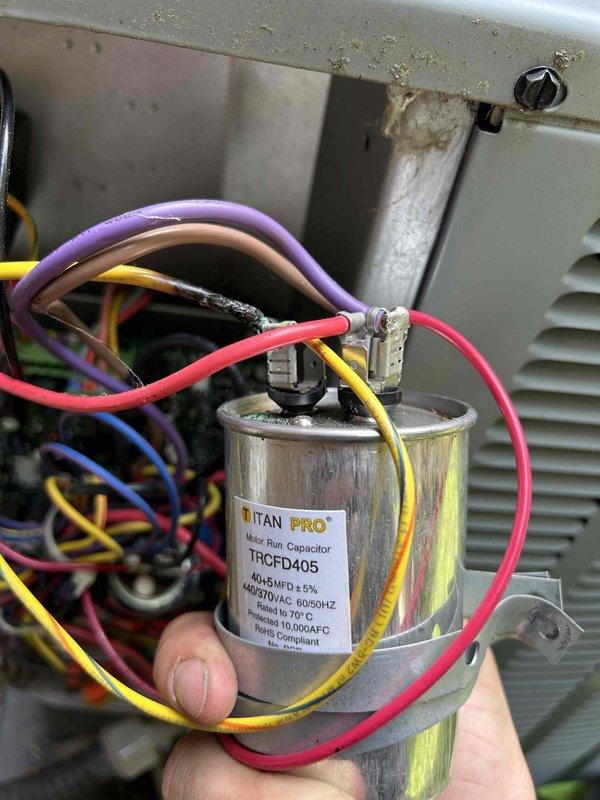 Responded to no cooling call on Goodman furnace/AC system with error code. Performed diagnostic evaluation and found failed run capacitor on outdoor condensing unit. Verified system temperatures at indoor unit showing elevated supply air temperature of 93°F, confirming lack of cooling. Replaced defective TITAN PRO run capacitor (model TRCFD405) with proper electrical connections, restored system operation, and verified proper cooling cycle. Noted heavily soiled air filter at indoor unit requiring replacement for optimal airflow and system efficiency.