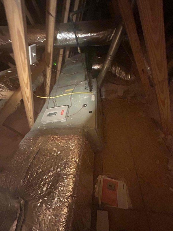 Responded to no cooling complaint on 7-year-old Goodman split system following recent power surges. Performed diagnostic evaluation of attic-mounted air handler and outdoor condensing unit. Inspected electrical connections, tested capacitors, verified refrigerant pressures, and checked control board functionality to identify surge-related damage preventing system operation.