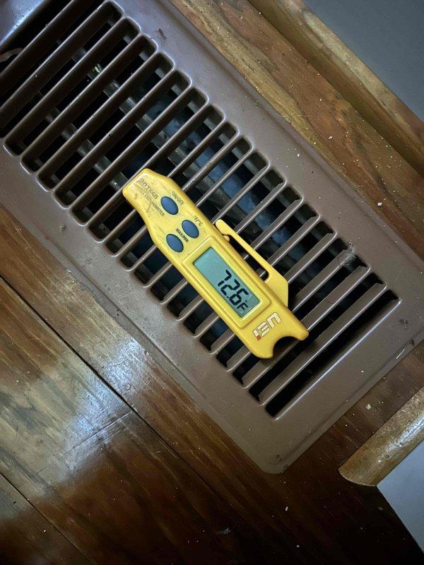 Responded to no cooling call on gas furnace with air conditioning system that had not been maintaining temperature for approximately one week. Upon arrival, found thermostat displaying 86°F actual temperature with 75°F setpoint, indicating significant temperature differential. Indoor unit located in crawlspace. Performed diagnostic evaluation of system including temperature measurements at supply registers, which recorded 72.6°F discharge air temperature. This reading indicates inadequate cooling capacity and suggests potential issues with refrigerant charge, airflow restriction, or compressor performance. Documented thermostat settings showing system in cooling mode with fan set to auto operation and low battery warning displayed. Further diagnostics required to isolate root cause of insufficient cooling performance.