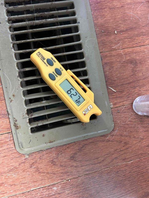 Responded to no cooling complaint on 15-year-old electric HVAC system with indoor unit located in crawlspace. Upon arrival, measured supply air temperature at floor register reading 62°F, indicating inadequate cooling performance. Accessed crawlspace and inspected air handler, ductwork, and associated components. Found extremely dirty air filter that had not been changed in approximately one year, causing restricted airflow and reduced system efficiency. Noted flex duct connections and insulation condition in attic space. Documented system conditions with thermal measurements and photographic evidence of equipment location and installation configuration.