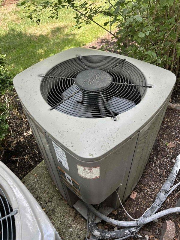 Responded to no cooling complaint on residential split system. Upon arrival, found outdoor condenser unit inoperative with history of continuous runtime prior to failure. Performed diagnostic evaluation of both outdoor condensing unit and indoor Lennox air handler. Inspected electrical connections, refrigerant lines, and system components. Documented equipment condition with photographs showing condenser unit positioned on concrete pad with flexible conduit connections and air handler installation in interior closet space with ductwork connections. System evaluated and findings reported to customer for repair authorization.