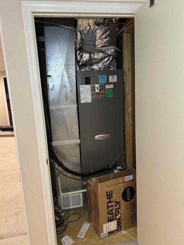 Responded to no cooling complaint on residential split system. Upon arrival, found outdoor condenser unit inoperative with history of continuous runtime prior to failure. Performed diagnostic evaluation of both outdoor condensing unit and indoor Lennox air handler. Inspected electrical connections, refrigerant lines, and system components. Documented equipment condition with photographs showing condenser unit positioned on concrete pad with flexible conduit connections and air handler installation in interior closet space with ductwork connections. System evaluated and findings reported to customer for repair authorization.