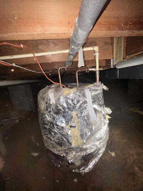 Completed installation of a Bradford White 50-gallon electric lowboy water heater in crawl space. Removed existing deteriorated unit showing severe insulation degradation and replaced with new basic model electric water heater. Connected copper supply lines, installed proper electrical connections via junction box, and ensured all plumbing and electrical connections met code requirements for safe operation in below-grade installation.