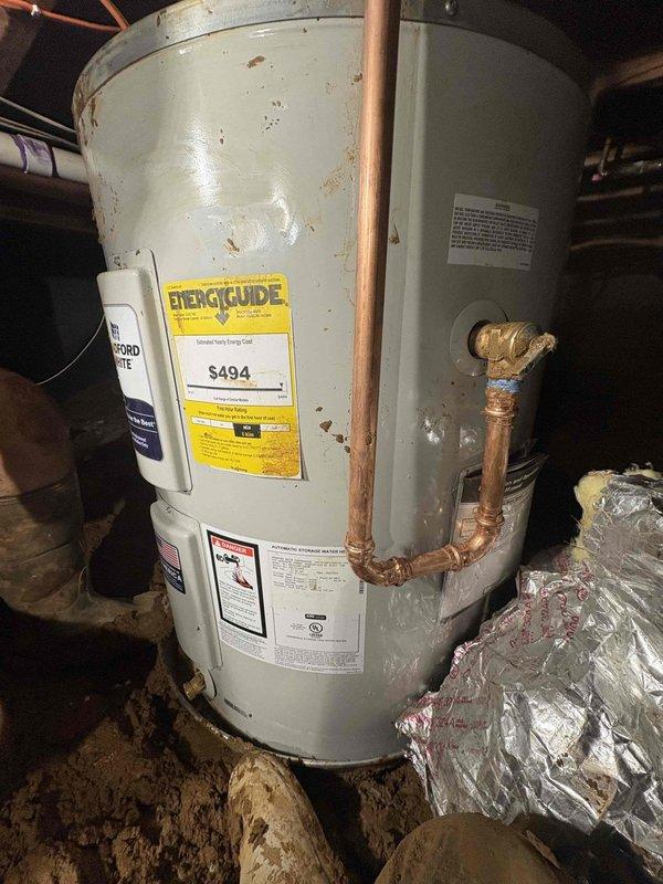 Completed installation of a Bradford White 50-gallon electric lowboy water heater in crawl space. Removed existing deteriorated unit showing severe insulation degradation and replaced with new basic model electric water heater. Connected copper supply lines, installed proper electrical connections via junction box, and ensured all plumbing and electrical connections met code requirements for safe operation in below-grade installation.