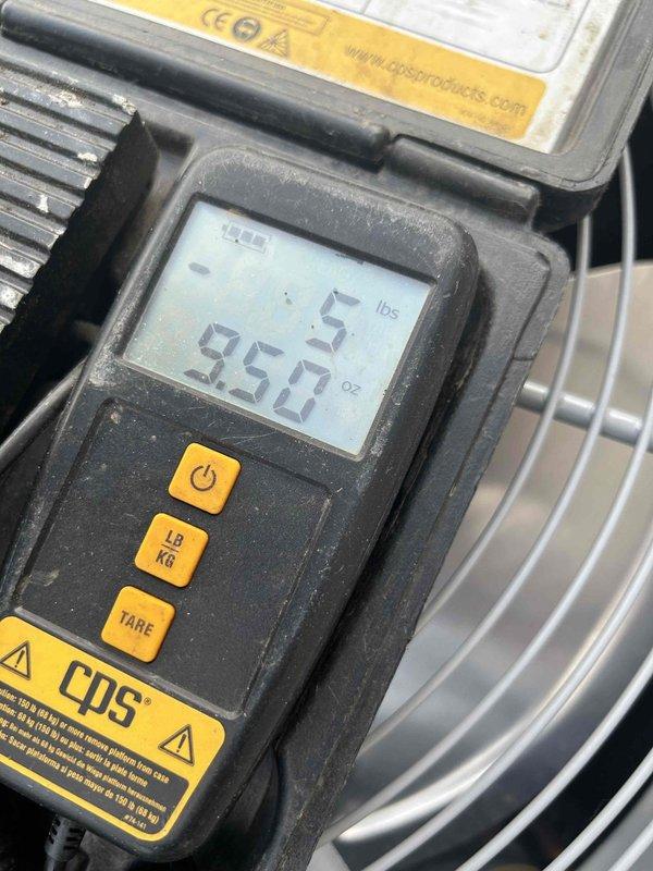 Responded to callback for HVAC system installed in April with no cooling and indoor temperature reaching 85°F. Upon inspection, discovered refrigerant charge was low at 950.5 lbs as indicated by digital scale reading. Examined refrigerant lines and connections in equipment cabinet, checking copper tubing runs and fittings for potential leaks or installation issues that may have caused loss of charge since original installation.