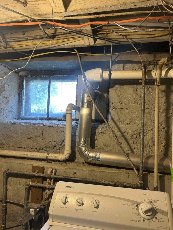 Provided plumbing estimate for rerouting sump pump discharge piping that currently runs through basement window. Assessment included evaluation of existing PVC drainage system, window replacement requirements, and proper exterior discharge routing to bring installation up to code while maintaining functional laundry room access.