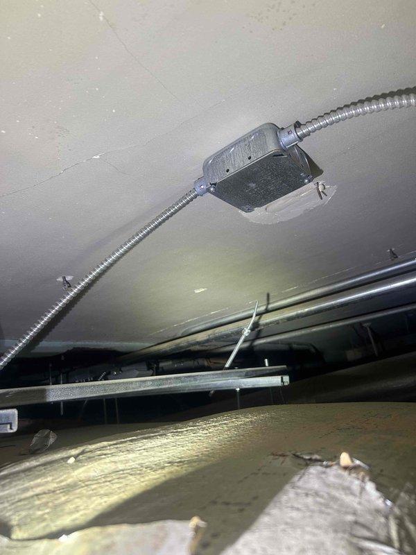 Responded to water leak complaint originating from HVAC system in drop ceiling area. Upon inspection, identified condensation issue on supply ductwork causing water dripping. Documented existing conditions including flex duct installation, mounting hardware, and insulation configuration in attic space. Advised customer of condensation source and recommended solutions to prevent future moisture accumulation on ductwork.