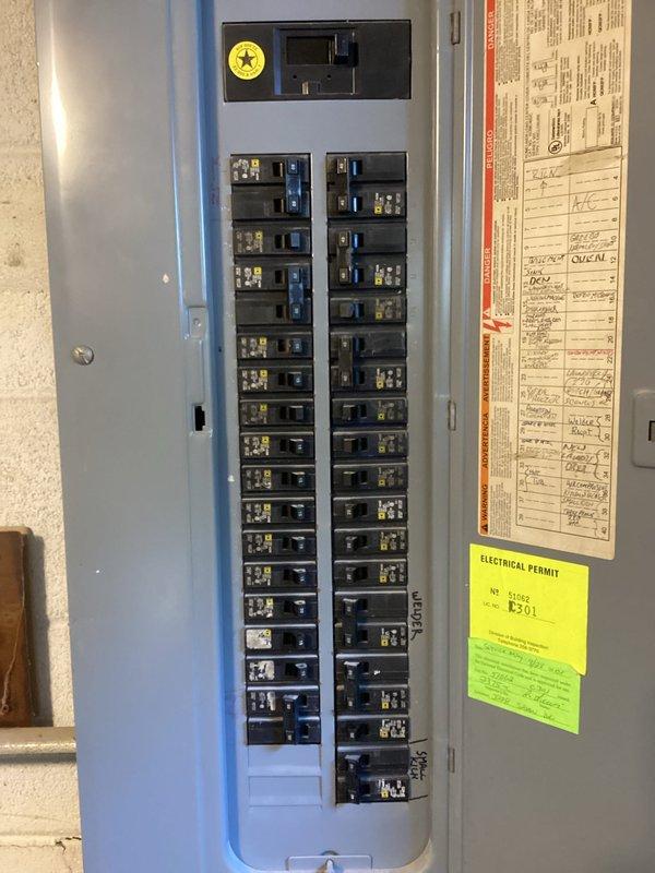 Conducted comprehensive site evaluation for backup generator installation at residential property. Assessed existing 200-amp main electrical panel with dual-column breaker configuration and documented current electrical infrastructure, including main disconnect switch and circuit distribution. Evaluated exterior installation location adjacent to building, noting existing utilities, AC unit placement, and accessibility considerations for generator pad placement and fuel line routing. Provided detailed photographic documentation of electrical panel interior, circuit directory, and exterior site conditions to develop accurate material and labor estimates for generator transfer switch installation and integration with existing electrical system.