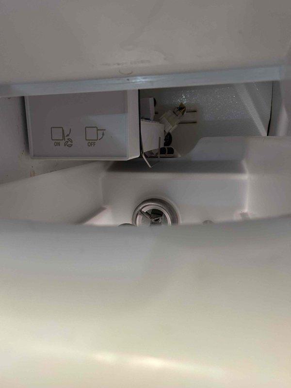 Completed ice maker installation to existing refrigerator unit. Routed water supply line through designated grommet port in appliance exterior panel and connected to refrigerator's internal water distribution system. Verified proper connection at ice maker compartment control panel and tested system functionality upon completion.