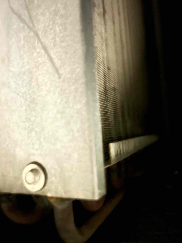 # No Cool Service Call - 20-Year-Old Carrier System

Responded to no cooling complaint on approximately 20-year-old Carrier split system. Performed diagnostic evaluation of both indoor air handler and outdoor condensing unit to isolate failure point. 

Upon inspection, accessed indoor evaporator coil assembly housed in vertical air handler cabinet. Coil showed age-related wear consistent with two decades of operation. Examined finned heat exchanger surfaces for blockage, damage, or deterioration. Assessed refrigerant line connections, condensate drainage system including PVC trap configuration, and electrical connections at unit.

Evaluated overall system condition noting advanced age of equipment at end of expected service life. Documented equipment nameplate data and current operational status. Photographed evaporator coil assembly and complete air handler installation including associated ductwork, refrigerant lines, and drainage piping for service records.

Provided customer with d