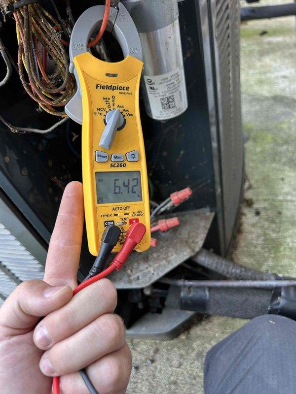 Completed annual preventative maintenance on seven-year-old residential air conditioning system. Performed comprehensive tune-up including inspection of blower wheel assembly, verification of electrical parameters using clamp meter with readings within normal operating range, and capacitor testing. System operating efficiently with no deficiencies noted; all components functioning properly.