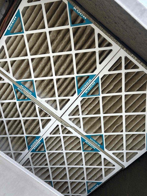 Responded to customer concern regarding excessive condensation on ductwork causing water dripping that was mistaken for a roof leak. Upon inspection, discovered heavily frosted refrigerant line and dirty evaporator coil fins with significant debris accumulation restricting airflow. Identified root cause as restricted airflow due to dirty coil and improper insulation on refrigerant lines, leading to below-dewpoint surface temperatures and subsequent condensation. Documented conditions with photos showing frost buildup on copper lines and contaminated coil fins requiring cleaning and insulation repair to resolve moisture issues.