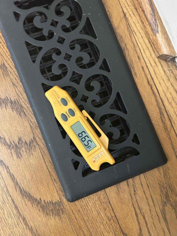 Responded to no cooling call on 12-year-old electric air conditioning system with indoor unit located in basement. Upon arrival, performed diagnostic testing and found system unresponsive. Used clamp meter to measure electrical current and voltage at compressor, recording 0.64 amps and 0.3 volts, indicating compressor failure. Measured supply air temperature at floor register reading 65.5°F, confirming lack of cooling. Diagnosed failed compressor as root cause of system failure. Discussed repair options with homeowner, noting age of unit and cost-effectiveness of replacement versus repair. Provided recommendations for next steps given the system's age and extent of failure.