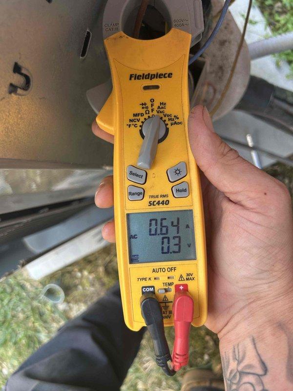 Responded to no cooling call on 12-year-old electric air conditioning system with indoor unit located in basement. Upon arrival, performed diagnostic testing and found system unresponsive. Used clamp meter to measure electrical current and voltage at compressor, recording 0.64 amps and 0.3 volts, indicating compressor failure. Measured supply air temperature at floor register reading 65.5°F, confirming lack of cooling. Diagnosed failed compressor as root cause of system failure. Discussed repair options with homeowner, noting age of unit and cost-effectiveness of replacement versus repair. Provided recommendations for next steps given the system's age and extent of failure.