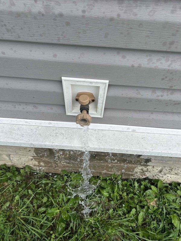 Completed comprehensive 65-point plumbing inspection of residential property without performing flush tests. Conducted exterior evaluation of hose bib mounted on building siding, confirming proper water flow and valve operation. Performed interior inspection of toilet tank components, verifying fill valve assembly, flush valve mechanism with flapper, and overflow tube functionality. Documented all findings with photographic evidence showing operational plumbing fixtures in standard working condition.