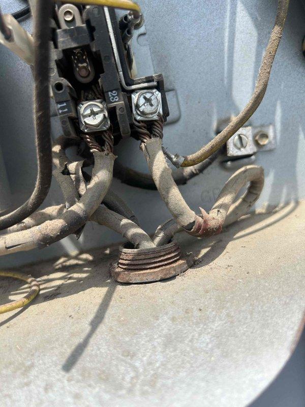 Responded to no cooling complaint on upstairs HVAC unit over 10 years old with indoor temperature reaching 85 degrees. Upon inspection, discovered heavy dust and debris accumulation on electrical connections and wiring at the air handler, including terminal blocks, connection points, and various control wires. The excessive buildup on electrical components and corroded connections were impeding proper system operation. Documented equipment condition with detailed photographs showing compromised wiring insulation and heavily soiled terminal assemblies requiring attention to restore safe and efficient system operation.