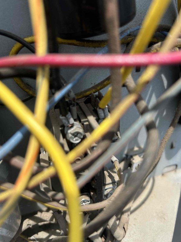 Responded to no cooling complaint on upstairs HVAC unit over 10 years old with indoor temperature reaching 85 degrees. Upon inspection, discovered heavy dust and debris accumulation on electrical connections and wiring at the air handler, including terminal blocks, connection points, and various control wires. The excessive buildup on electrical components and corroded connections were impeding proper system operation. Documented equipment condition with detailed photographs showing compromised wiring insulation and heavily soiled terminal assemblies requiring attention to restore safe and efficient system operation.