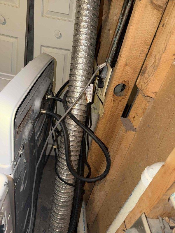 Conducted electrical inspection of 25-year-old residential property in response to customer concerns regarding possible incorrect wiring on unspecified appliances. Performed comprehensive visual assessment of electrical systems in attic utility space and laundry area, examining electrical cables, junction boxes, and appliance connections serving HVAC equipment and laundry appliances. Inspected bundled electrical cables routed along wooden framing, verified proper connections at electrical junction box and disconnect switch, and assessed wiring integrity at appliance locations. Documented existing electrical installation conditions with photographic evidence for customer records and future reference.