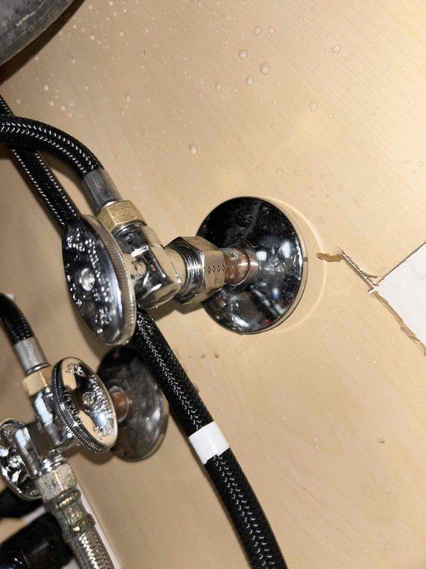 Responded to water leak at 1/2" shut-off valve underneath kitchen sink. Upon inspection, identified leak at compression fitting connection on wall-mounted shut-off valve. Tightened compression nut on braided flexible supply line connection to eliminate active leak. Verified all connections were secure and tested system for proper operation with no further leakage detected.