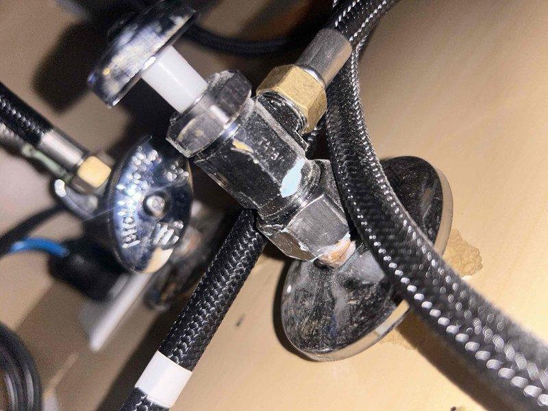 Responded to water leak at 1/2" shut-off valve underneath kitchen sink. Upon inspection, identified leak at compression fitting connection on wall-mounted shut-off valve. Tightened compression nut on braided flexible supply line connection to eliminate active leak. Verified all connections were secure and tested system for proper operation with no further leakage detected.