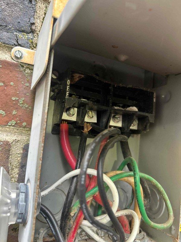 Responded to no cooling complaint on residential HVAC system. Upon arrival, located outdoor disconnect and found severe electrical failure at terminal block with extensive heat damage, charring, and evidence of sustained arcing at wire connections. The burned terminals and melted housing indicated dangerous overheating condition that prevented system operation. Disconnected power and condemned the failed disconnect due to fire hazard. Explained to customer that complete disconnect replacement is required before system can be safely restored to operation, along with full system evaluation to determine if additional damage occurred to compressor or other components from the electrical fault.