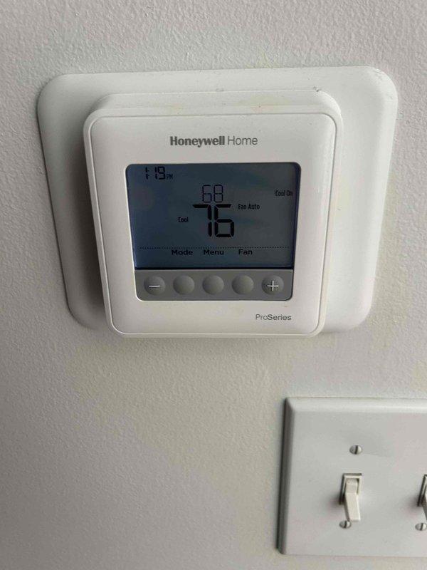 Responded to no-cool call for downstairs air conditioning system that had been inoperative for one week. Upon arrival, found Honeywell Home ProSeries thermostat calling for cooling with system showing "Cool On" mode, display reading 76°F actual temperature with 68°F setpoint. Inspected outdoor condensing unit installed approximately 2.5 years prior and verified electrical disconnect, refrigerant line set, and condensate drain installation. Diagnosed system malfunction and restored cooling operation to downstairs zone.