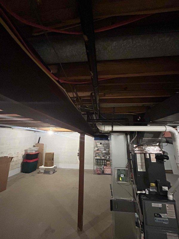 Conducted on-site evaluation for tankless gas water heater installation in residential property. Assessed existing basement utility area including current plumbing infrastructure, gas line accessibility, and venting requirements. Documented existing HVAC system placement, electrical panel location, and available wall space for tankless unit mounting. Evaluated ceiling-mounted water supply lines and drainage configuration to determine connection points and required modifications. Measured clearances and identified optimal installation location considering manufacturer specifications for combustion air, venting pathways, and service access. Photographed existing conditions including structural support posts, exposed joists, and utility routing to develop comprehensive installation plan and material requirements for tankless water heater conversion.
