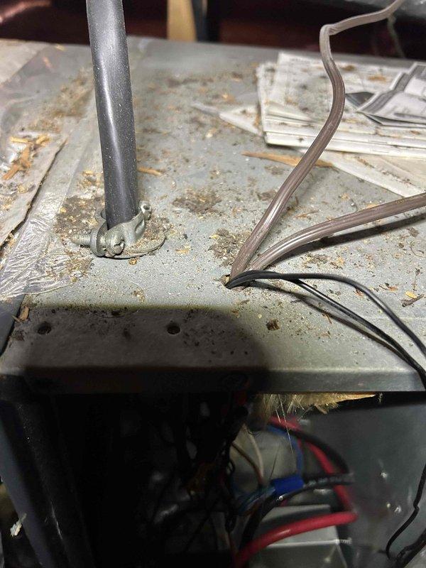 Responded to no-cooling call on 9-year-old upstairs AC unit that had previously been quoted for UV light installation. Upon arrival, performed diagnostic inspection of the system and documented exterior condition of equipment showing weathering and normal wear patterns. Inspected internal wiring compartments and electrical connections, capturing photos of panel surfaces and internal wiring bundles for service records.
