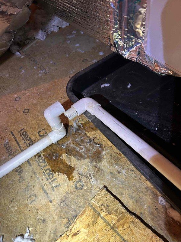 Responded to service call for water damage on ceiling below attic-mounted HVAC unit. Upon inspection, confirmed active water staining with yellowish-brown discoloration indicating moisture infiltration from above. Accessed attic space and located indoor air handler with condensate drainage system. Identified compromised drain pan showing signs of overflow due to primary condensate drain line obstruction. Cleared blockage from PVC condensate line, verified proper drainage flow, and inspected drain pan for cracks or damage. Tested system operation through complete cooling cycle to ensure condensate is properly draining and no further leakage is occurring. Recommended monitoring ceiling stain for any expansion and advised that existing cosmetic damage will require separate repair once area has fully dried.