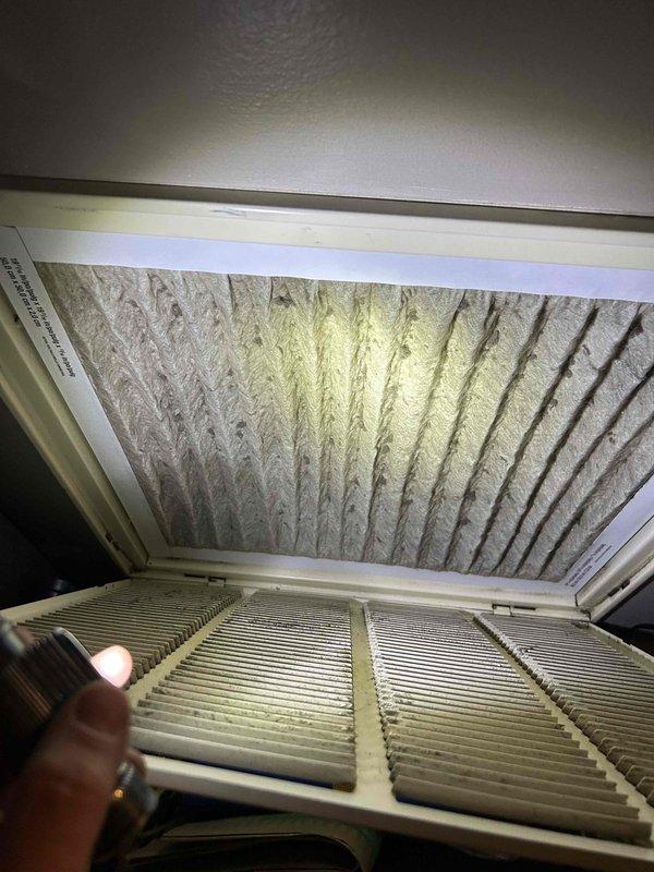 Responded to non-urgent service call for drain pan filling up and overflowing on residential HVAC system. Upon arrival, inspected air handler unit and identified clogged condensate drain line as primary cause of water accumulation. Evaporator coil showed visible dust and debris buildup on fins, contributing to restricted airflow and excess condensation. Cleared condensate drain line obstruction using appropriate methods to restore proper drainage. Verified drain pan was emptying correctly after clearing blockage. Recommended filter replacement and coil cleaning to prevent future drainage issues and maintain system efficiency. Unit cooling properly at time of service completion with condensate draining as designed.