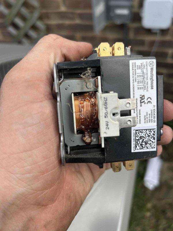 Responded to no-cool call on 9-year-old Lennox system with thermostat reporting loss of power to air conditioning unit. Upon inspection, discovered failed contactor with severely burned and deteriorated copper coil windings showing extensive heat damage and corrosion. Replaced defective contactor, verified proper voltage at thermostat, confirmed fresh batteries installed, and restored full system operation with normal cooling cycle.