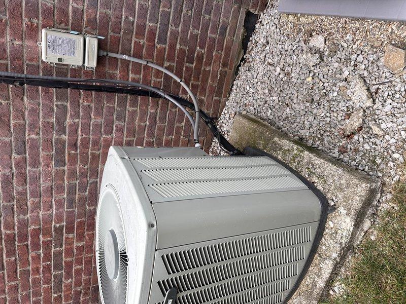 Conducted comprehensive site assessment for complete HVAC system replacement involving 2.5-ton Carrier heat pump system. Evaluated existing heat pump and air handler configuration with indoor unit located in attic space requiring ladder access for inspection. Documented current equipment conditions including attic-mounted air handler with flexible ductwork and exterior condensing unit positioned on weathered concrete pad against brick wall foundation. Photographed installation environment including attic structural framing, insulation coverage, equipment placement, and outdoor unit location with electrical disconnect and conduit routing. Provided detailed replacement estimate for new Carrier heat pump system sized appropriately for existing application.