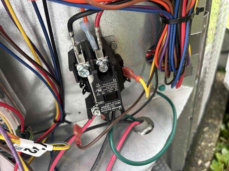 Responded to callback for recently installed heat pump system not cooling properly. Found air handler operational but unit not responding to thermostat cooling calls with indoor temperature reading 78°F while set to cool to 78°F. Accessed air handler unit in above-garage location and inspected electrical connections at control panel. Identified contactor issue preventing compressor operation. Verified proper wiring connections, tested control voltage, and restored system to proper cooling operation. Confirmed thermostat communication with outdoor unit and verified system cycling correctly on cooling demand.