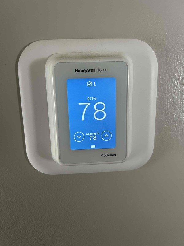 Responded to callback for recently installed heat pump system not cooling properly. Found air handler operational but unit not responding to thermostat cooling calls with indoor temperature reading 78°F while set to cool to 78°F. Accessed air handler unit in above-garage location and inspected electrical connections at control panel. Identified contactor issue preventing compressor operation. Verified proper wiring connections, tested control voltage, and restored system to proper cooling operation. Confirmed thermostat communication with outdoor unit and verified system cycling correctly on cooling demand.