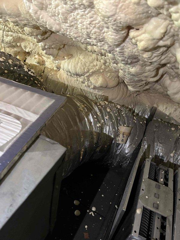 Repaired multiple runs of flexible ductwork in attic space to improve airflow distribution to upstairs rooms. Work included addressing worn and damaged duct sections showing significant dust accumulation and deterioration. Repairs were performed in areas with spray foam insulation and limited access points near the furnace location.
