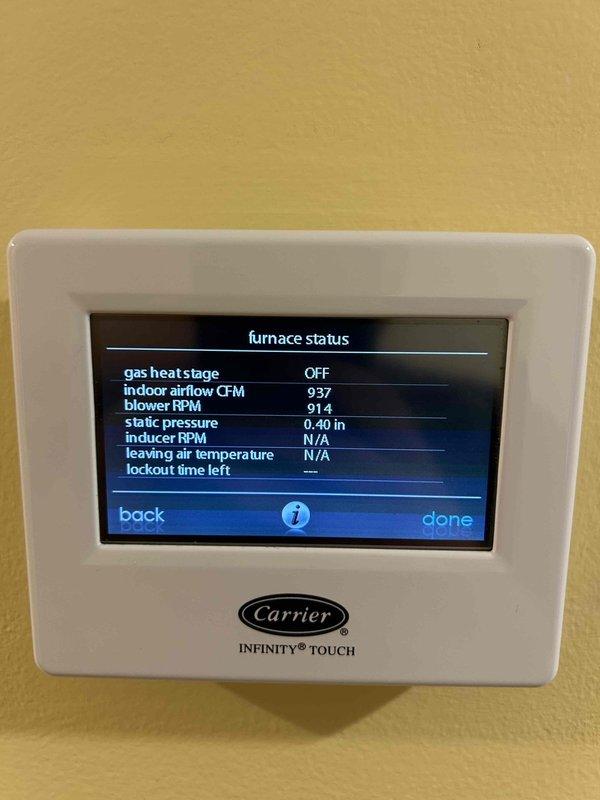 Responded to no cooling complaint on Carrier Infinity system that had been producing excessive water for two weeks. Upon inspection, found air filter in satisfactory condition and system operational with furnace in standby mode. Verified thermostat functionality showing proper airflow at 937 CFM, blower operating at 914 RPM, and static pressure reading 0.40 inches. Diagnosed issue as condensate drainage problem causing water accumulation at indoor unit located in laundry area.