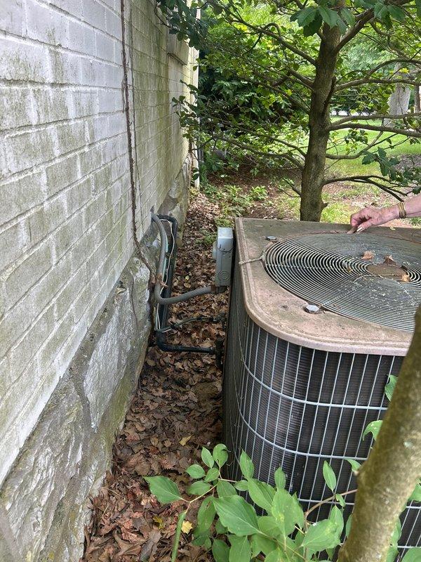 Responded to no cooling call affecting entire home. Upon arrival, inspected outdoor condensing unit and indoor air handler system. Outdoor unit showed signs of age and weathering with visible discoloration on top panel. Indoor equipment located in basement included furnace with connected air handler and auxiliary components. Performed diagnostic evaluation of complete HVAC system to identify cause of cooling failure. Documented equipment condition and configuration with photos for service records. System brand and age were unknown at time of service, though equipment showed moderate wear consistent with several years of operation.