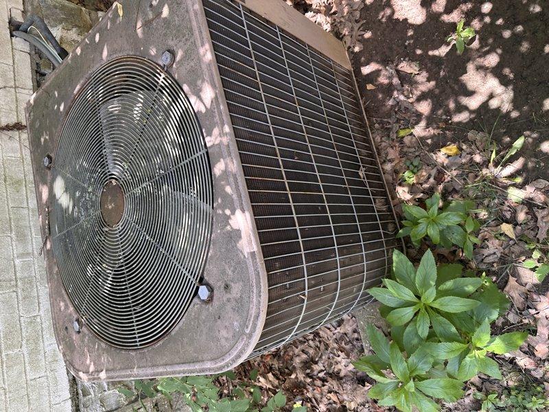 Responded to service call for non-functional air conditioning system affecting entire residence. Conducted on-site evaluation of existing HVAC equipment, including outdoor condenser unit and indoor air handler. Documented current system condition through comprehensive photography, noting aged outdoor unit with weathered housing, operational fan assembly, and heat exchanger coils showing signs of extended service life. Interior air handler located in basement mechanical room, mounted on block foundation with visible gas connections and electrical components. Prepared complete system replacement estimate based on equipment age, condition assessment, and whole-home cooling requirements.