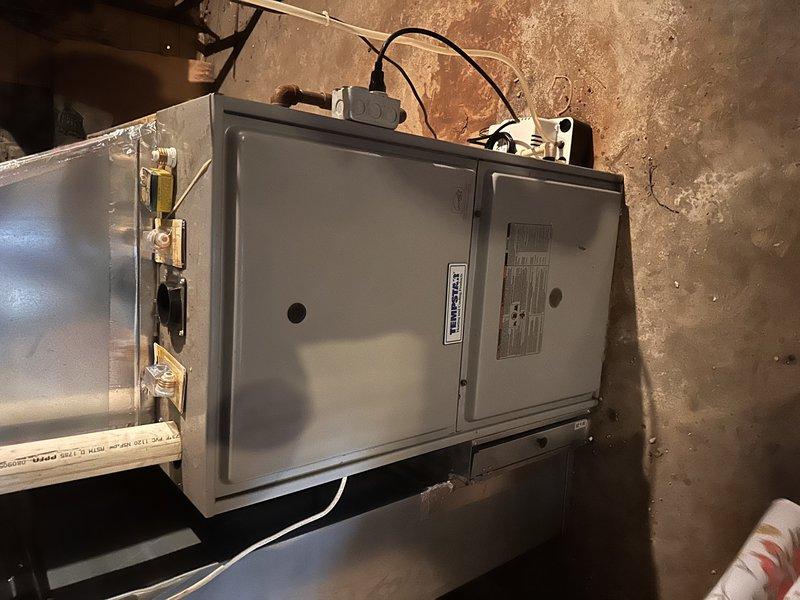 Responded to service call for non-functional air conditioning system affecting entire residence. Conducted on-site evaluation of existing HVAC equipment, including outdoor condenser unit and indoor air handler. Documented current system condition through comprehensive photography, noting aged outdoor unit with weathered housing, operational fan assembly, and heat exchanger coils showing signs of extended service life. Interior air handler located in basement mechanical room, mounted on block foundation with visible gas connections and electrical components. Prepared complete system replacement estimate based on equipment age, condition assessment, and whole-home cooling requirements.