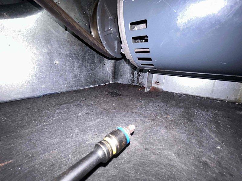 Responded to service call for 8-year-old Carrier system experiencing abnormal loud operational noises. Upon inspection, discovered significant heat damage and soot staining on interior metal panels indicating electrical failure or component burnout. Identified failed blower motor assembly as source of excessive noise and thermal damage. Removed and replaced defective blower motor with OEM equivalent component. Cleaned heat-affected areas, inspected all electrical connections for secondary damage, and verified proper amperage draw. System tested successfully with normal sound levels and full cooling operation restored.