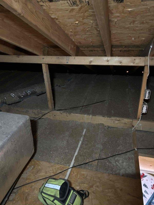 # HVAC Service Report - No Cool Issue

Responded to service call for upstairs heat pump system not maintaining adequate cooling performance. Unit is approximately 17 years old. Upon inspection, accessed attic-mounted air handler and associated ductwork to diagnose system performance issues. 

Visual inspection revealed flexible duct runs servicing the upstairs zone, with insulation materials present throughout attic space. Examined air handler installation, ductwork connections, and insulation integrity. Documented attic conditions including exposed wooden framing, radial barrier insulation on attic floor, and HVAC component placement. Assessed overall system configuration and identified potential factors contributing to insufficient cooling capacity in the upstairs zone.

Collected diagnostic fee for attic inspection and initial system evaluation. Customer advised of findings and recommendations for restoring proper cooling performance to affected area.