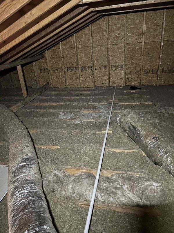 # HVAC Service Report - No Cool Issue

Responded to service call for upstairs heat pump system not maintaining adequate cooling performance. Unit is approximately 17 years old. Upon inspection, accessed attic-mounted air handler and associated ductwork to diagnose system performance issues. 

Visual inspection revealed flexible duct runs servicing the upstairs zone, with insulation materials present throughout attic space. Examined air handler installation, ductwork connections, and insulation integrity. Documented attic conditions including exposed wooden framing, radial barrier insulation on attic floor, and HVAC component placement. Assessed overall system configuration and identified potential factors contributing to insufficient cooling capacity in the upstairs zone.

Collected diagnostic fee for attic inspection and initial system evaluation. Customer advised of findings and recommendations for restoring proper cooling performance to affected area.