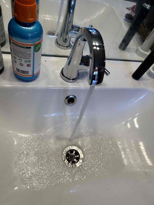Responded to upstairs master bathroom plumbing issue where the right side vanity faucet exhibited low water pressure and leaking from the handle. Disassembled the faucet assembly and diagnosed a failed cartridge in a discontinued Delta faucet model with replacement parts only available direct from manufacturer. After consultation, full faucet replacement was authorized. New faucet unit ordered for installation at subsequent appointment. Inspection of supply connections revealed deteriorated hot water shut-off valve requiring replacement during faucet installation to ensure proper system function and prevent future leaks.
