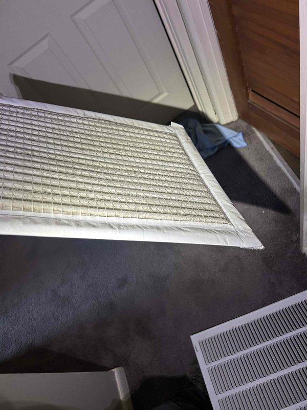 Responded to no cooling complaint on unit #4 with history of multiple compressor replacements. Performed diagnostic evaluation of system operation, checked thermostat functionality showing 70-degree cooling setpoint, and inspected air return filter grille at interior threshold location. Contacted property manager with diagnostic findings prior to proceeding with any repairs per special instructions, and documented system conditions with photos for review.